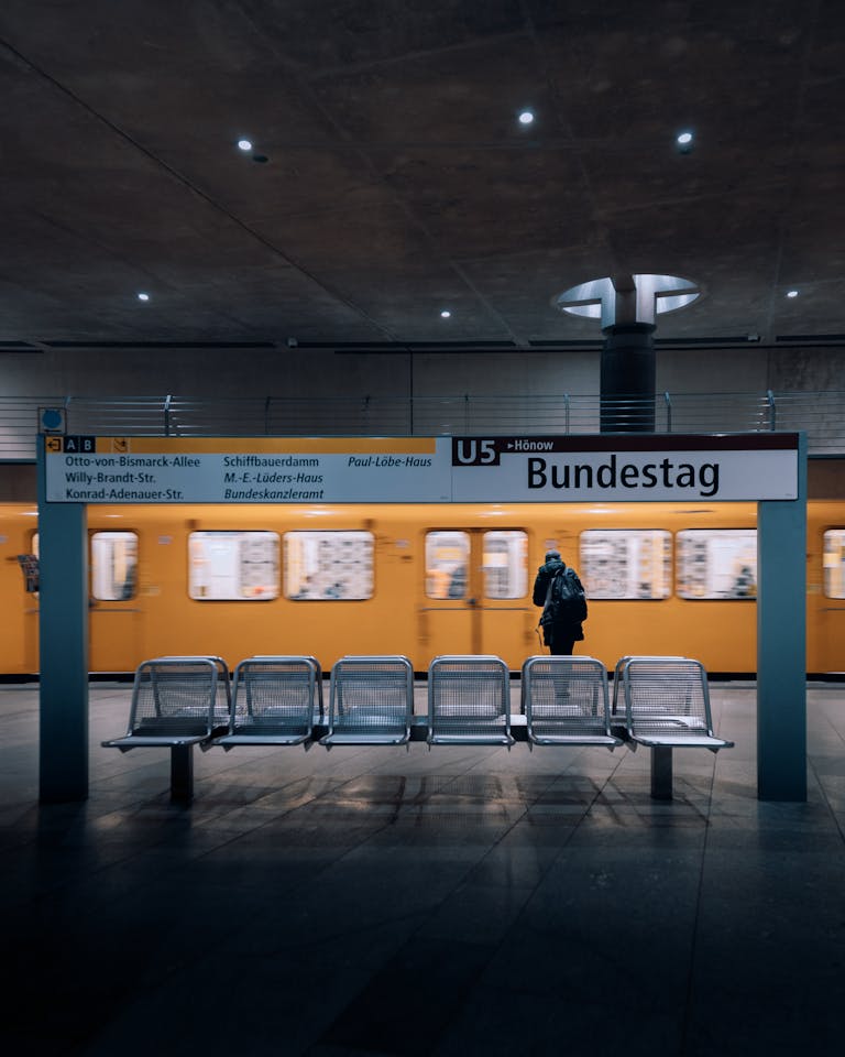 Bundestag U-Bahn station in Berlin with U5 train passing by. Captures urban transit atmosphere.