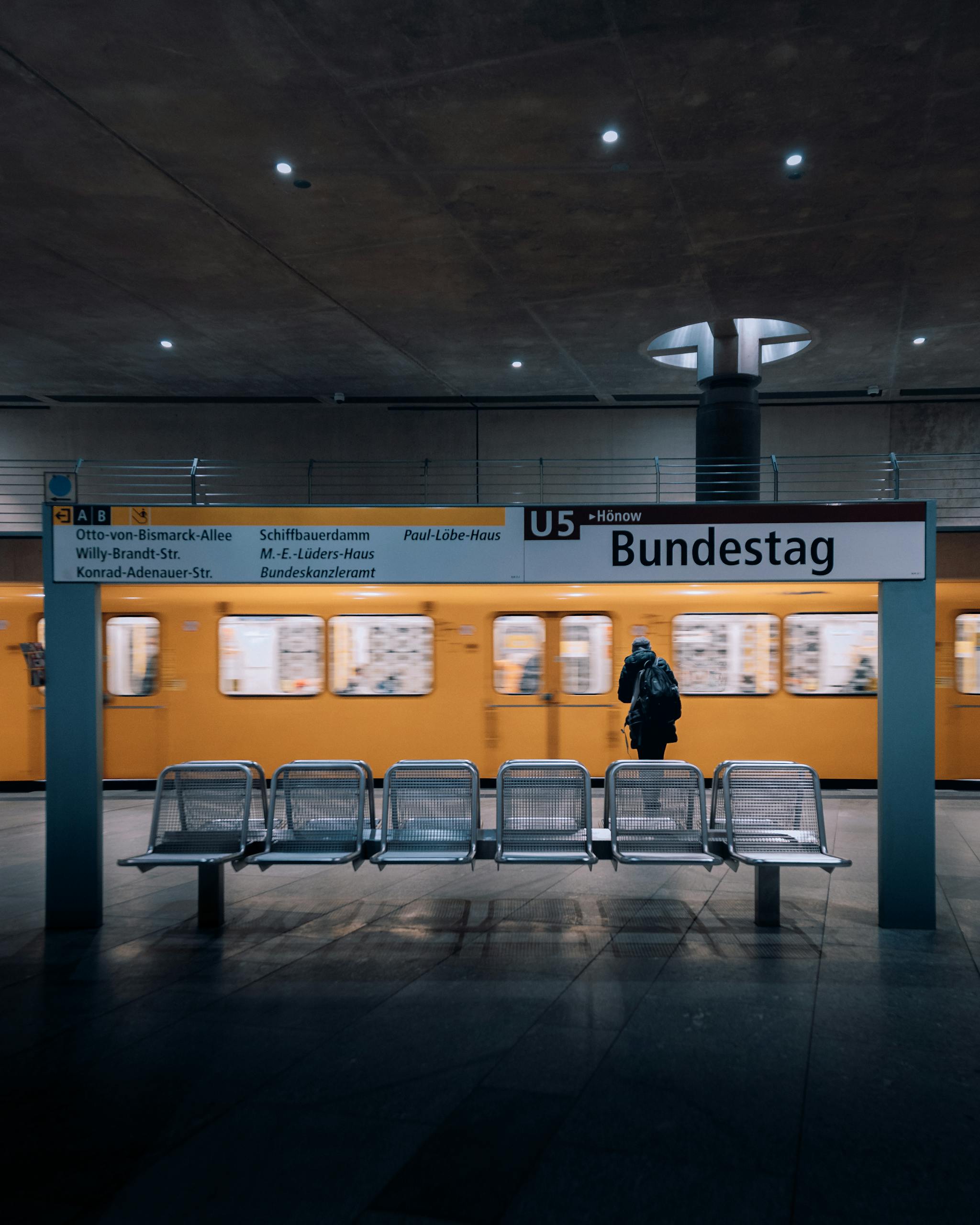 Bundestag U-Bahn station in Berlin with U5 train passing by. Captures urban transit atmosphere.