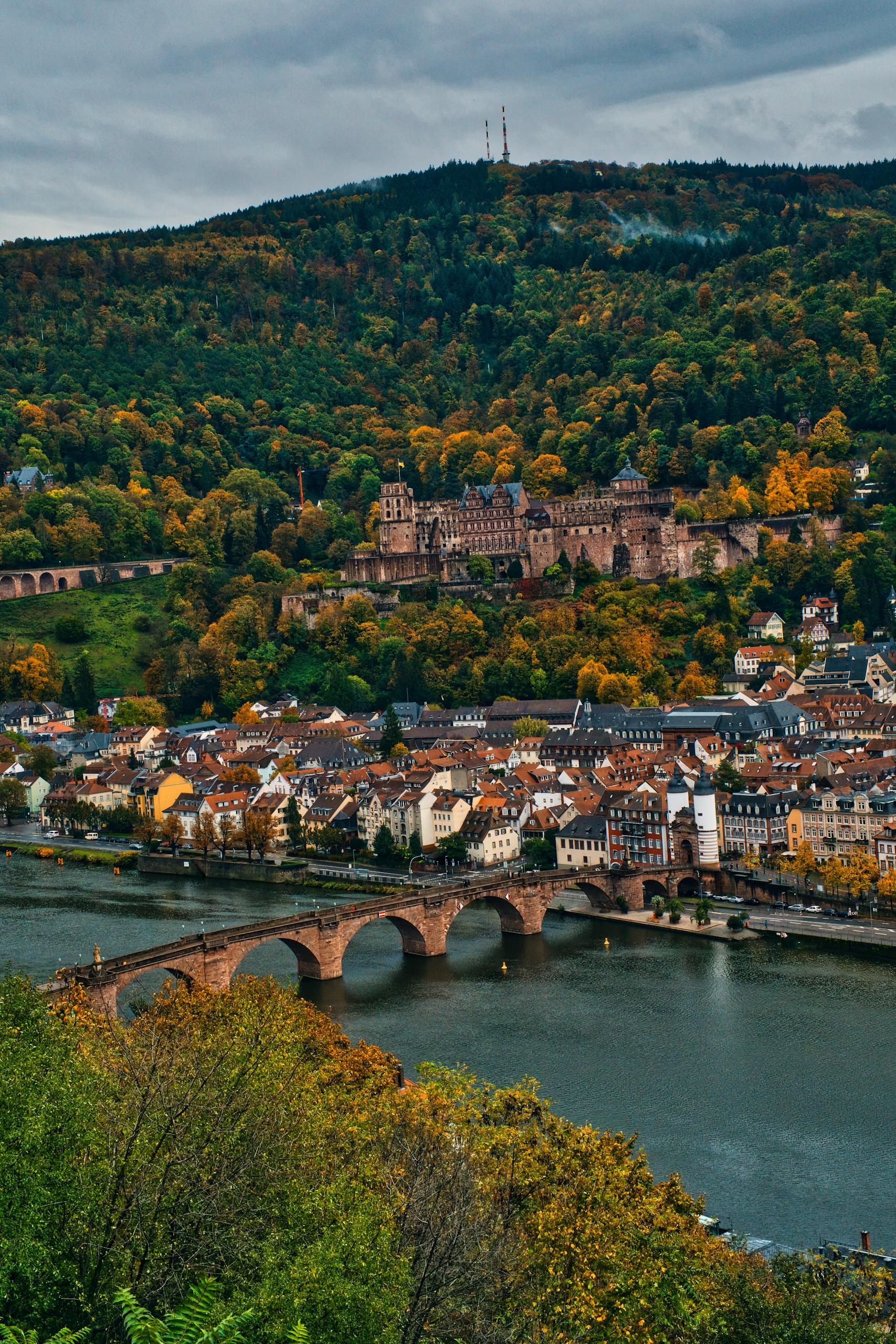 Captivating view of Heidelberg Castle and the Old Bridge over the Neckar River in autumn.