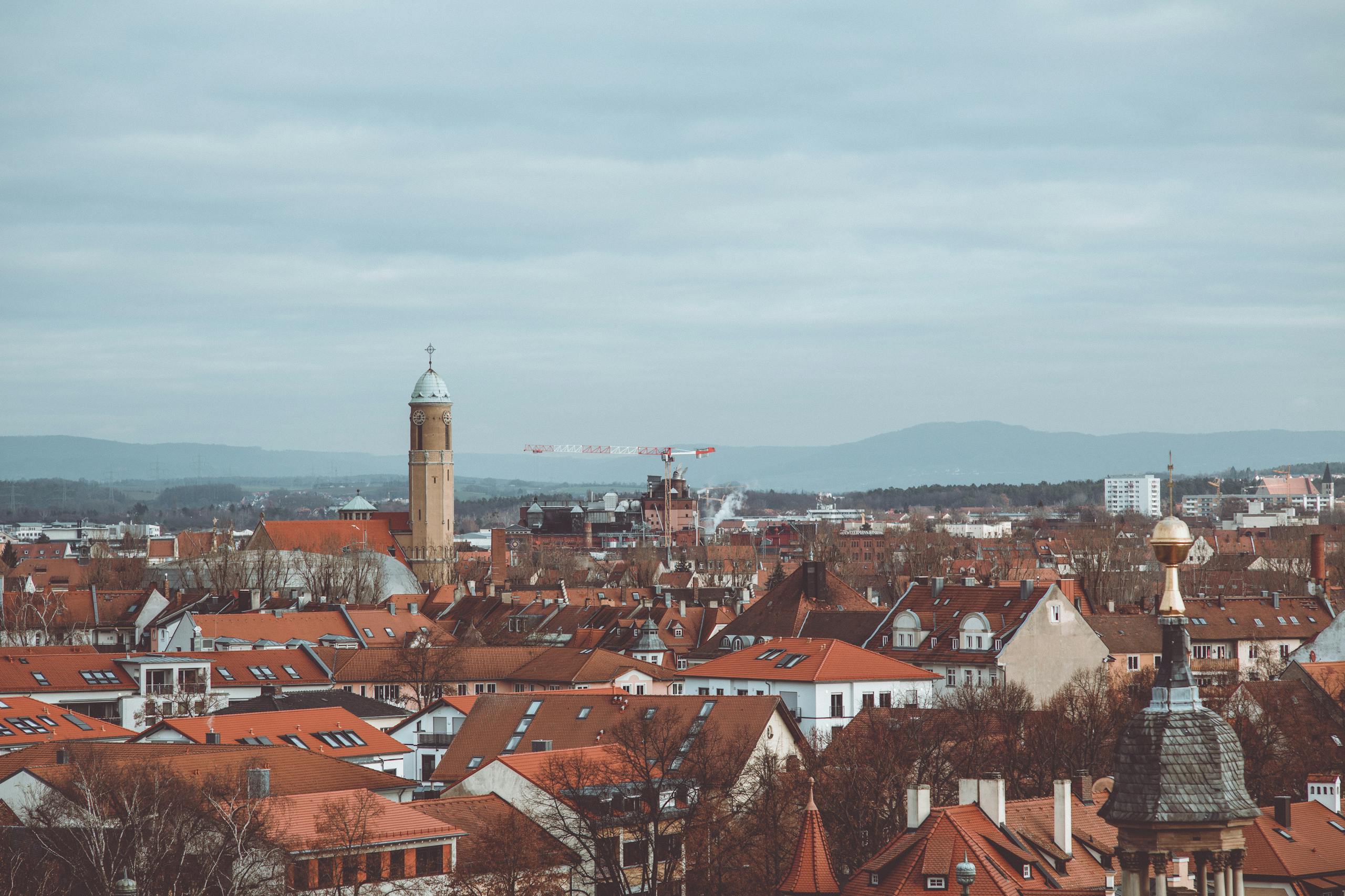 Explore the charming red rooftops of historic Bamberg under a cloudy sky. A scenic blend of architecture and culture.