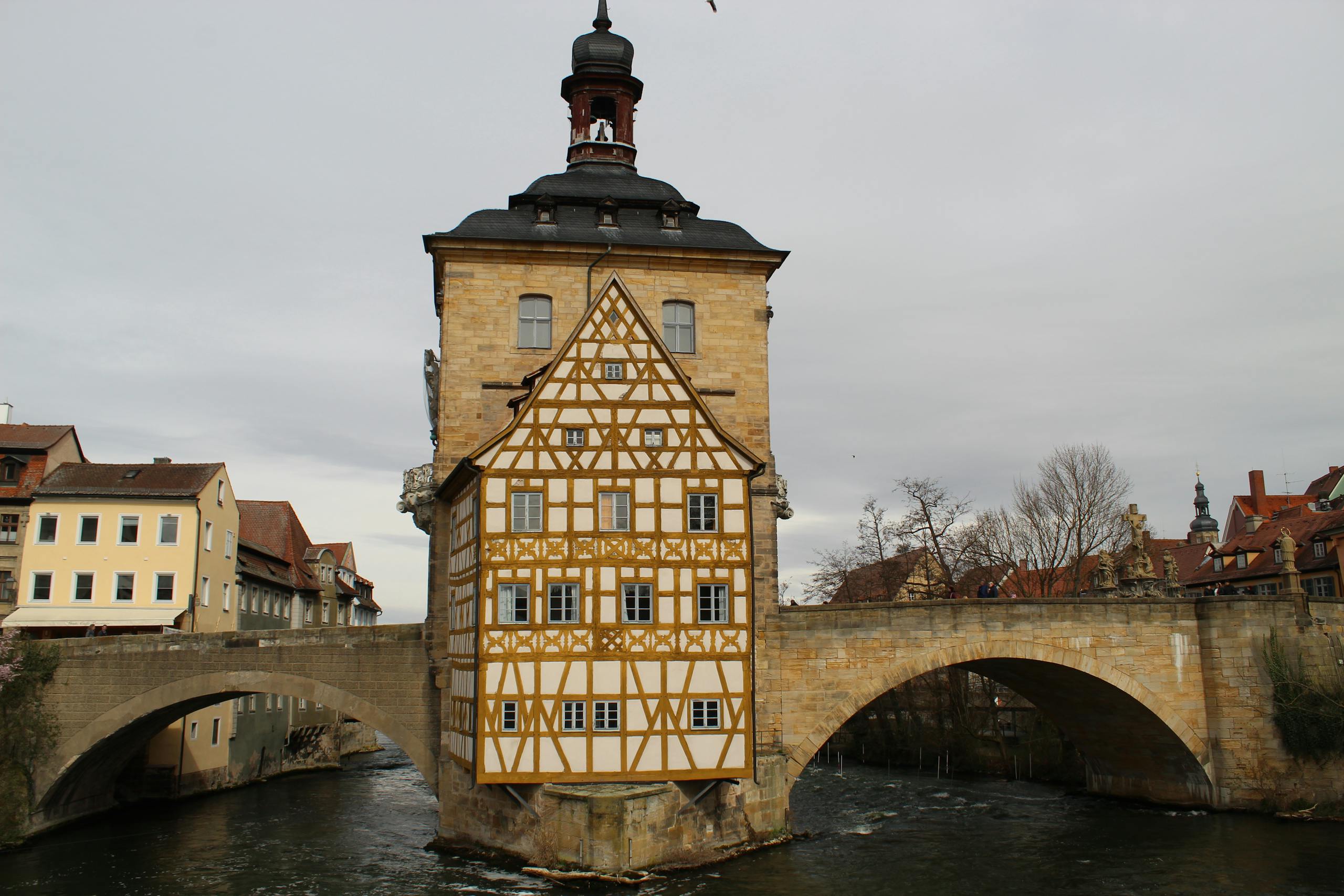 Scenic view of Bamberg's Altes Rathaus, a half-timbered building on the Regnitz River bridge.